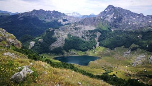 a view of a mountain valley with a lake at Katun Mokra accommodation & horseback riding in Podgorica