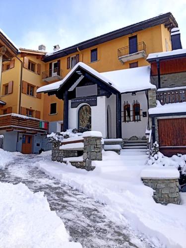a building with snow in front of it at MadeBoutique Rooms in Madesimo