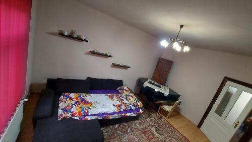 a living room with a couch and a mirror at Old Town Apartament Oradea in Oradea