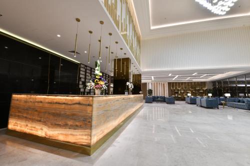 a lobby with a reception desk in a building at JUFFAIR BOULEVARD HOTEL & SUITES in Juffair