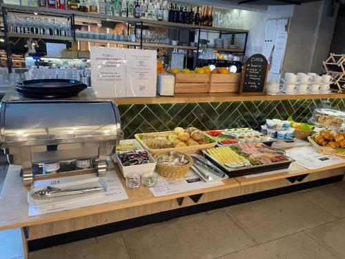 a counter in a store with food on it at Hotel Wielopole in Krakow