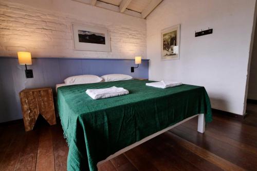 En eller flere senge i et værelse på Pousada do Morro