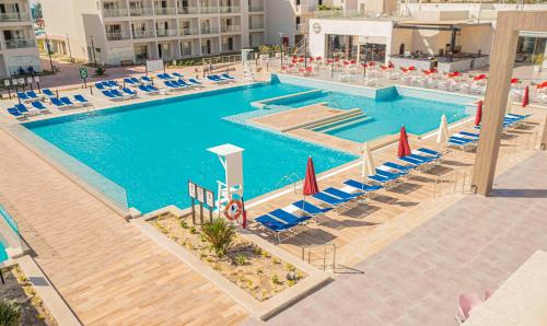an overhead view of a swimming pool with chairs and umbrellas at Amarina Abu Soma Resort & Aquapark in Hurghada