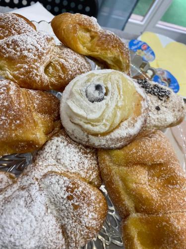 a pile of donuts with powdered sugar on them at Maison De luxe in Pompei