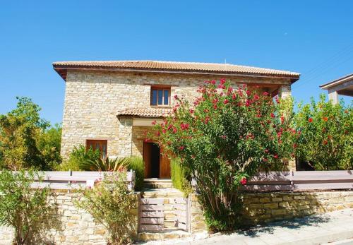 a stone house with flowers in front of it at Unique Stonehouse Traditional Villa in Ayia Anna in Ayia Anna