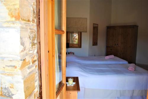 a bedroom with a bed and a window at Unique Stonehouse Traditional Villa in Ayia Anna in Ayia Anna