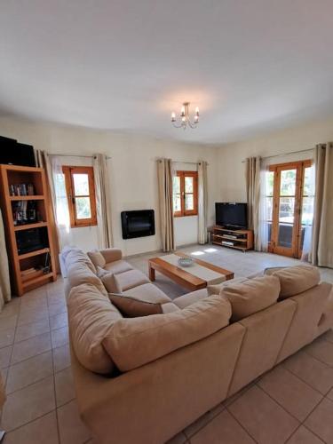 a large living room with a large couch at Unique Stonehouse Traditional Villa in Ayia Anna in Ayia Anna