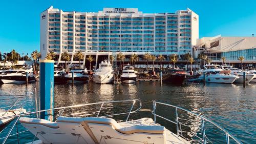 a group of boats docked in a marina with a hotel at Mr. Cliff Yachts in Quarteira