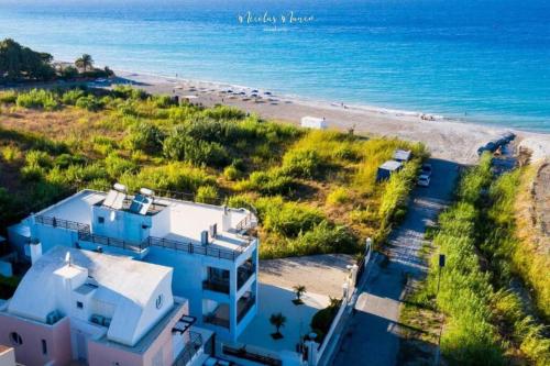 an aerial view of a house and the beach at White&Blue luxury suites in Ialyssos