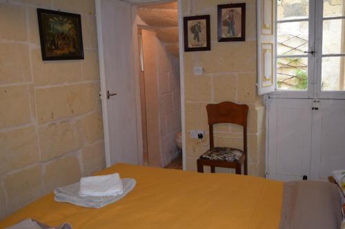 a room with a table and a chair and a window at Maria Townhouse Heart of Victoria B&B in Victoria