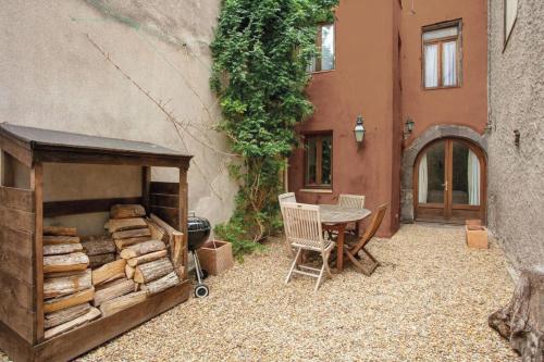 a patio with a table and a pile of wood at Marseillan 18th Century 2-Bed House Sleeps 6 in Marseillan