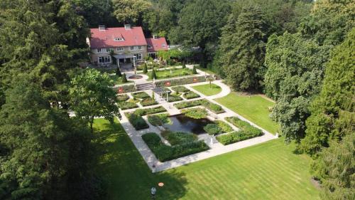 an aerial view of a house with a garden at Amsterdamgarden - stunning garden villa with pool close to Amsterdam in Laren