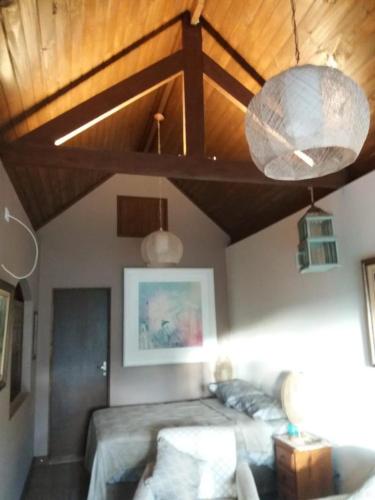 a bedroom with a bed and a wooden ceiling at Refúgio das Araucárias in Ibiúna