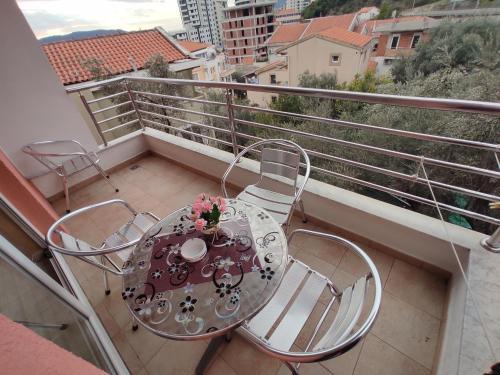 a balcony with a table and chairs on a balcony at Villa Aleksandra - T in Rafailovici