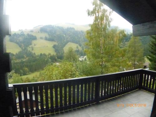 a balcony with a view of a valley at Charming chalet with panoramic view and private parking in Gruyère in Gruyères