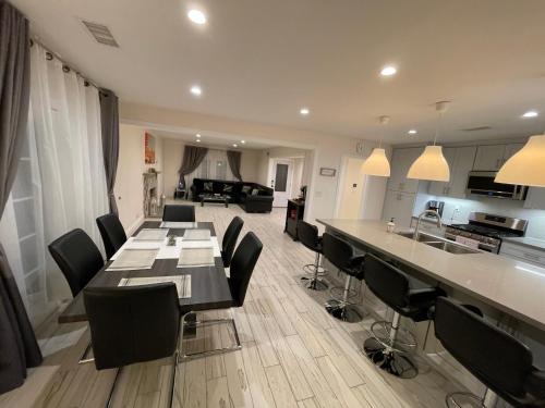 a kitchen and living room with a long table and chairs at Cheerful, Beautifully Remodeled, Modern, Comfortable Home in Los Angeles