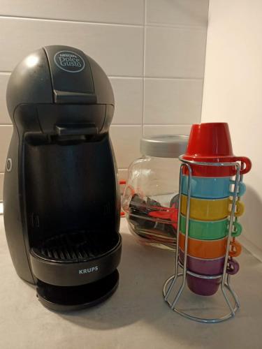 a coffee maker sitting on a counter next to a cup at LE GINESTRE in Sulmona