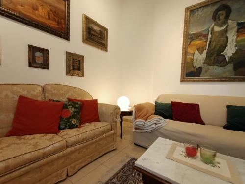 a living room with two couches and a table at LE GINESTRE in Sulmona
