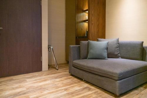 a couch sitting in a living room next to a door at Tsang Kuo Resort in Wujie