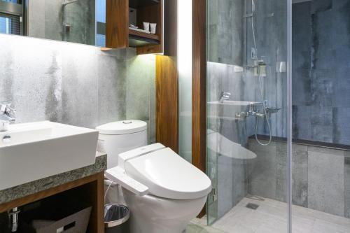 a bathroom with a toilet and a sink and a shower at Tsang Kuo Resort in Wujie