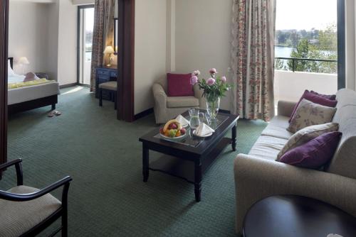 a living room with a couch and a table at Margarona Royal Hotel in Preveza