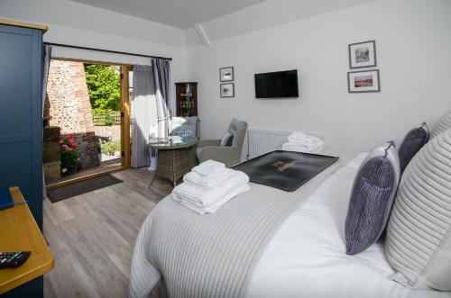 a bedroom with a bed and a living room at Lavender Lodge in Arundel