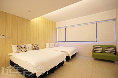 a hotel room with two beds and a large window at Meng Yun Ge Hotel in Jiaoxi