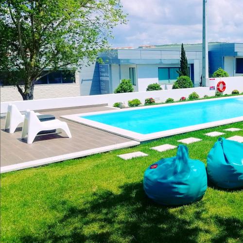 a swimming pool in a yard with two inflatable substances at Furnaka Eco Village in Lourinhã