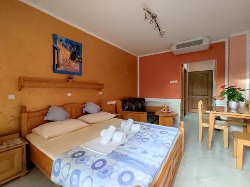 a bedroom with a large bed and a table at Villa Aleksandra - T in Rafailovici