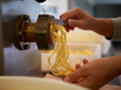 a person is holding a piece of spaghetti at Gasthof Ginzinger in Mauerkirchen