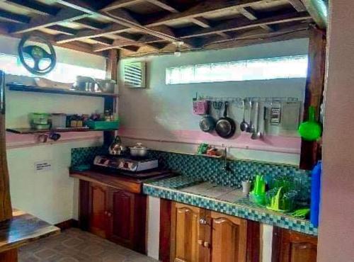 a kitchen with a stove and a counter top at Phielle In-Home Calayo House Rental in Nasugbu