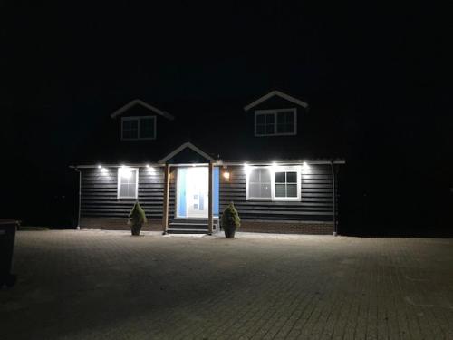 a house with lights in front of it at night at Vakantiehuis Ervedriestreek in Den Ham