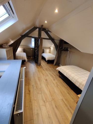 a room with two beds in a attic at La fa'Meuse escale in Vireux-Wallerand