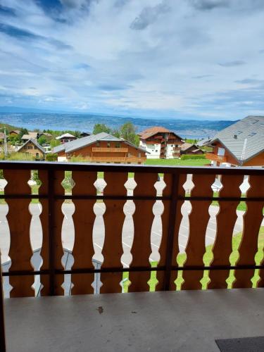 a wooden fence with a view of a city at Le Rhodo in Thollon