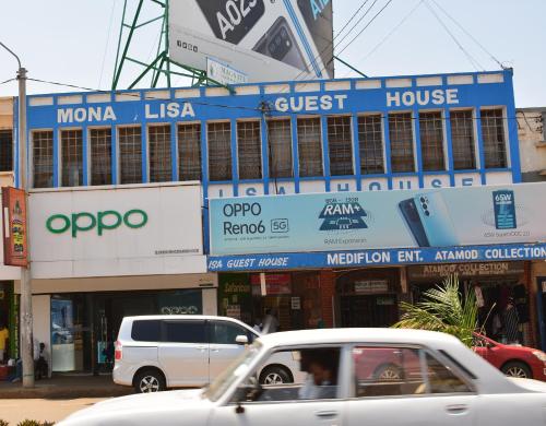 a street with cars parked in front of a guest house at Mona Lisa Guest House, Kisumu in Kisumu