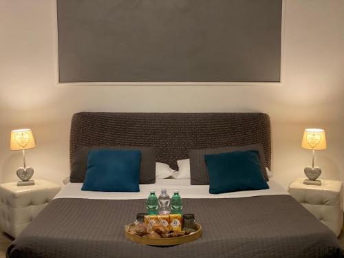 a bedroom with a bed with a tray of food on it at AgriSesto B&B in Fregene