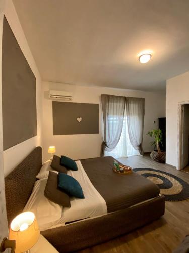 a bedroom with a large bed and a window at AgriSesto B&B in Fregene
