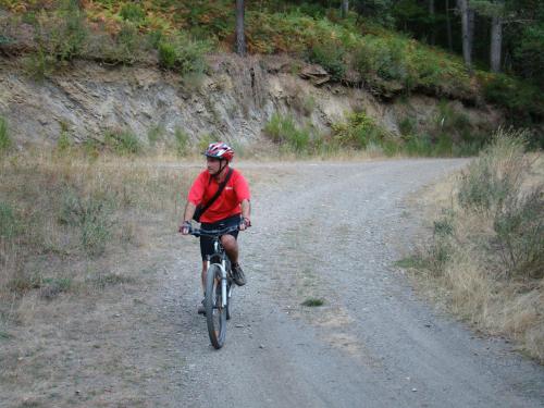 a man riding a bike down a dirt road at King Garfield House - Espaço de charme em Bragança in Bragança