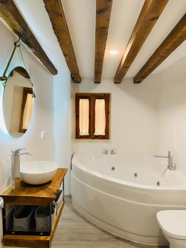 a bathroom with a large tub and a sink at La Moneda Home Spa in Cuenca