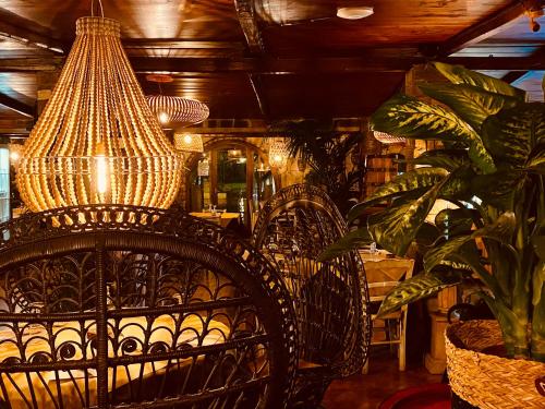 a dining room with a chair and a chandelier at AgriSesto B&B in Fregene