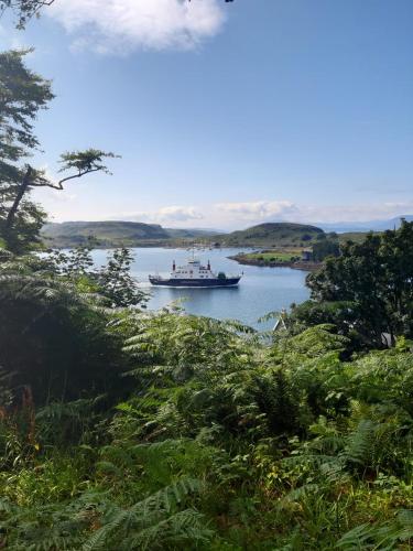 a boat in a large body of water at Pier View Apartment in Oban
