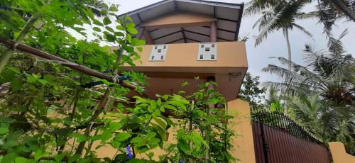 a building with two windows on the side of it at Chao Beach Villa in Ahangama