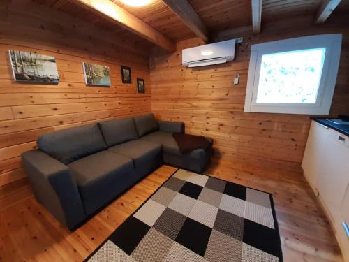 a living room with a couch and a window at Söpölä in Alvajärvi