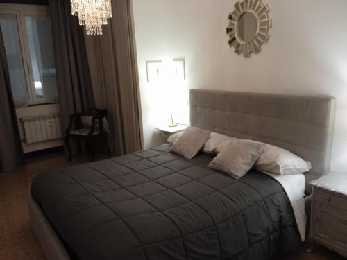 a bedroom with a bed and a mirror on the wall at Acquario Inn Genova House in Genoa