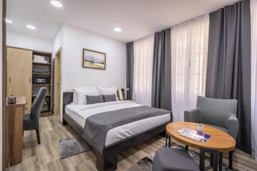 Postel nebo postele na pokoji v ubytování Vila Greta by Hotel Ramonda