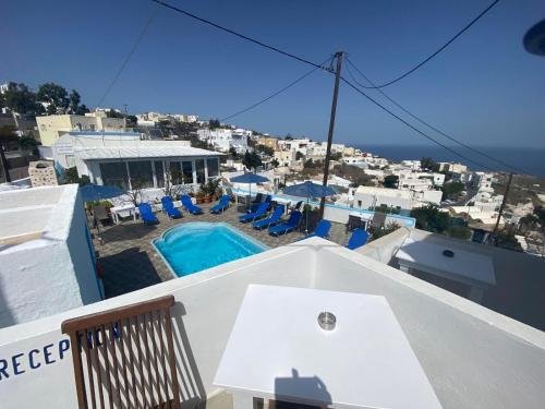 a view of a pool from the roof of a house at Stella Nomikou Apartments in Firostefani