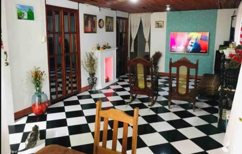 a room with a black and white checkered floor at Typical House Bluefields in Bluefields