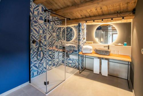 ein Bad mit einem Waschbecken und einem Spiegel in der Unterkunft Mochoruralhome matarraña suite in Beceite