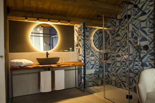 a bathroom with a sink and a mirror at Mochoruralhome ulldemo suite in Beceite