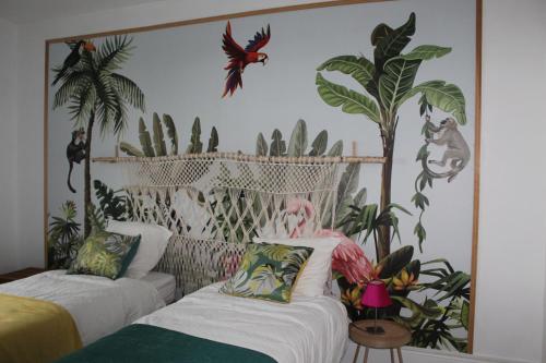 a room with two beds with plants on the wall at Maison LC in Cramant